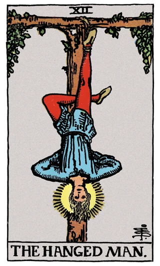 The Hanged Man Rider-Waite-Smith tarot card showing a haloed figure hanging by one foot from a wooden frame.
