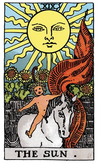 The Sun Rider-Waite-Smith tarot card showing a joyful child on a white horse beneath the sun and sunflowers.