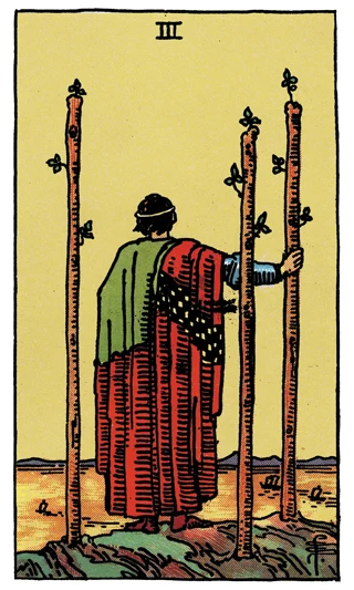 Three of Wands Rider-Waite-Smith tarot card showing a figure with three wands watching ships from a cliff.