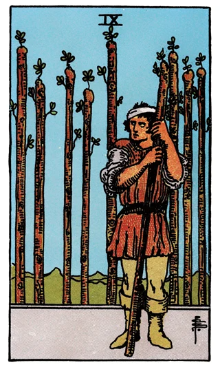 Nine of Wands Rider-Waite-Smith tarot card showing a bandaged figure holding a wand before a row of eight others.